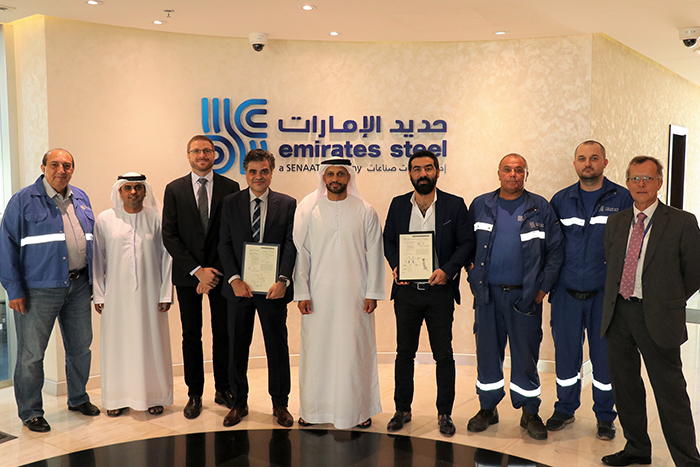 Eng. Saeed Ghumran Al Remeithi with Emirates Steel employees and the patent certificates.