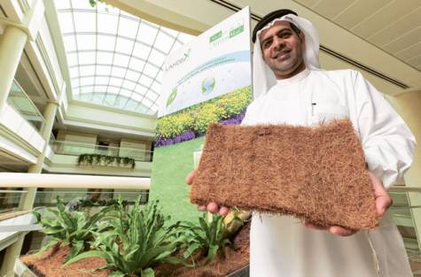 Khalfan Al Rahoomi, chairman of Landex, displaying a sample of the company’s Green Mat<br>material that is said to save a significant amount of water.