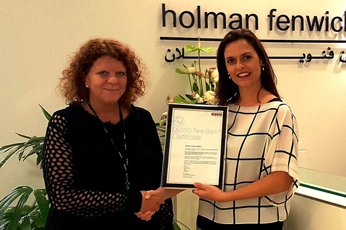 Karen Morgan, Holman Fenwick Willan Middle East LLP receives Take Back certificate from Nicole de Kort, Design Manager, Middle East, India & Africa, Desso.