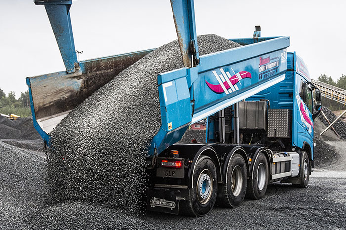 The dump body in the pictures is made with Hardox 500 Tuf in the bottom plate. It has transported over 40,000 metric tons of crushed rock during more than a year with very low wear. Measuring the thickness at the end section of the 6 mm bottom plate showed an average wear of only 5%.